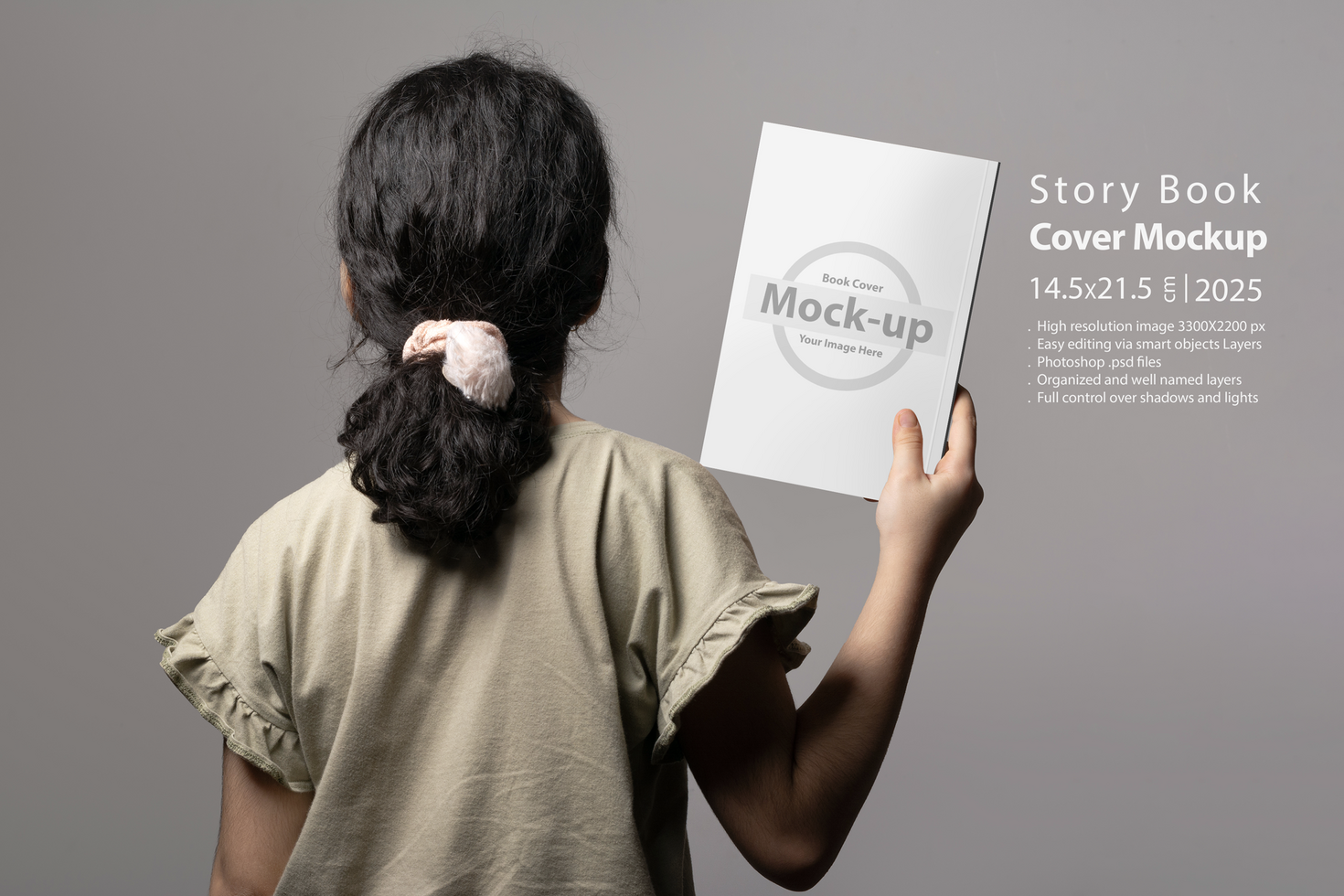 Backside of a little girl holding a novel book inside hand mock-up series psd