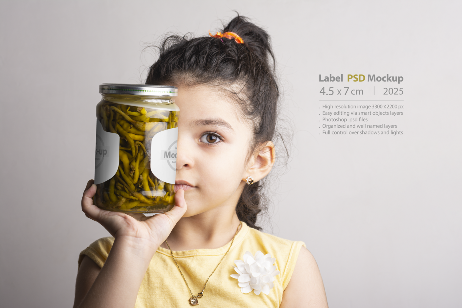 Little girl holding a Pickled pepper glass conserve in front of face mock-up series psd