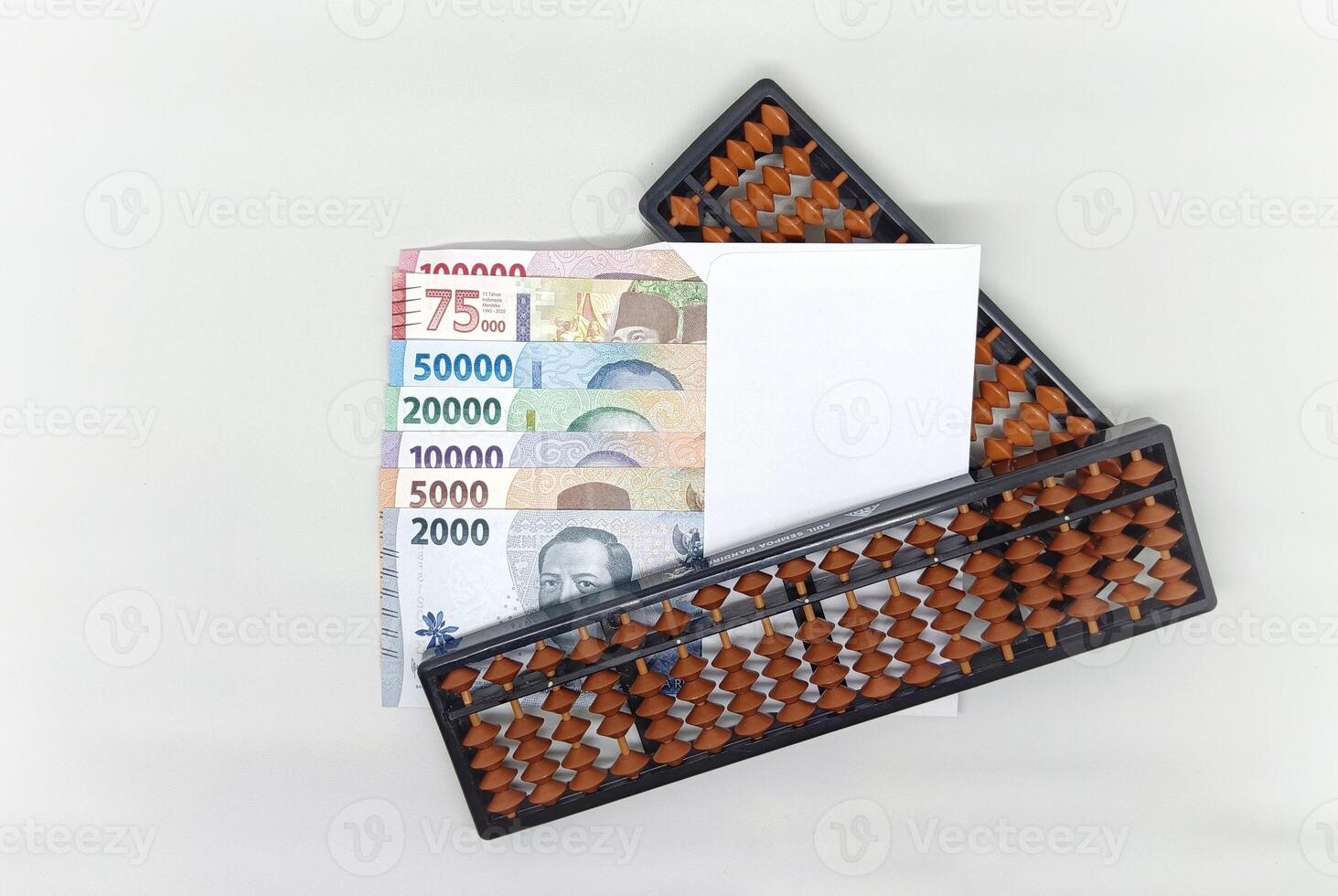abacus and Indonesian banknotes in white envelope. Collection of banknotes in denominations 2000, 5000, 10000, 20000, 50000, 75000, 10000 rupiah photo