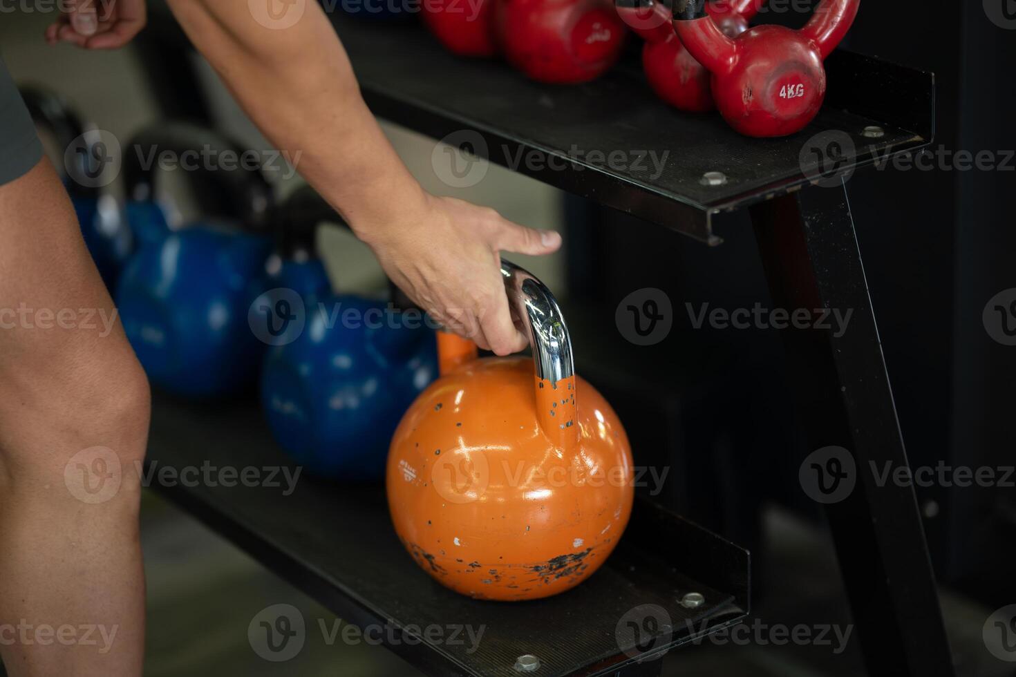 A close up shot of a man gripping dumbbells, ready to push through his intense workout in the gym, displaying focus, strength, and determination photo
