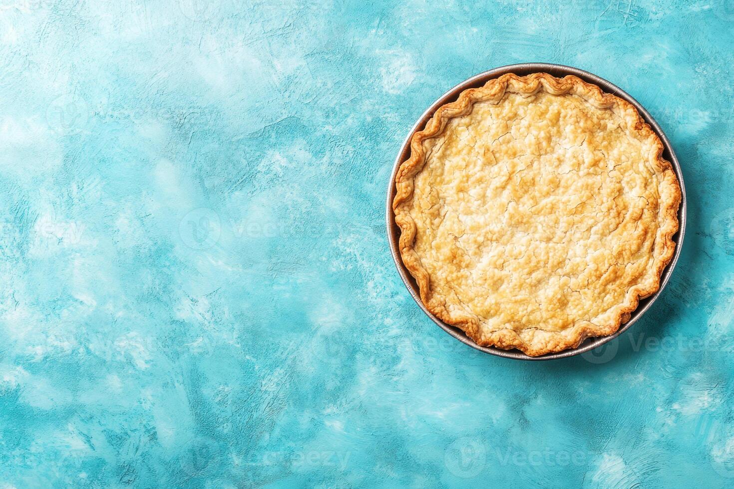 Freshly baked pie resting on a turquoise surface photo