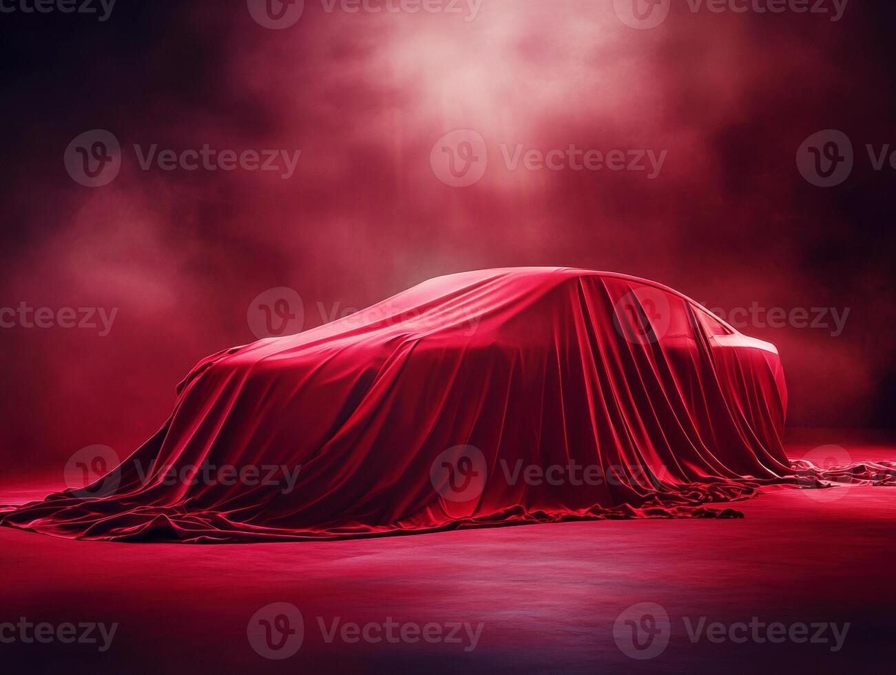 Luxury car covered with red cloth in a dramatic setup photo