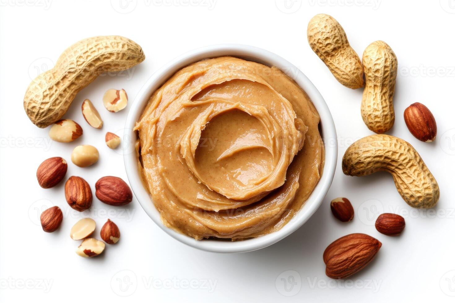 Creamy peanut butter with various nuts arranged on a white surface photo