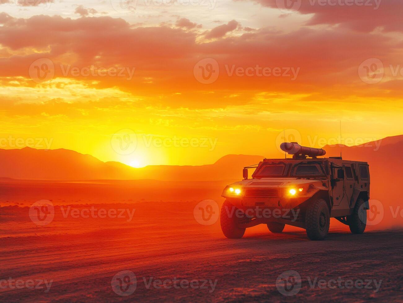 Military vehicle drives through desert at sunset with orange sky photo