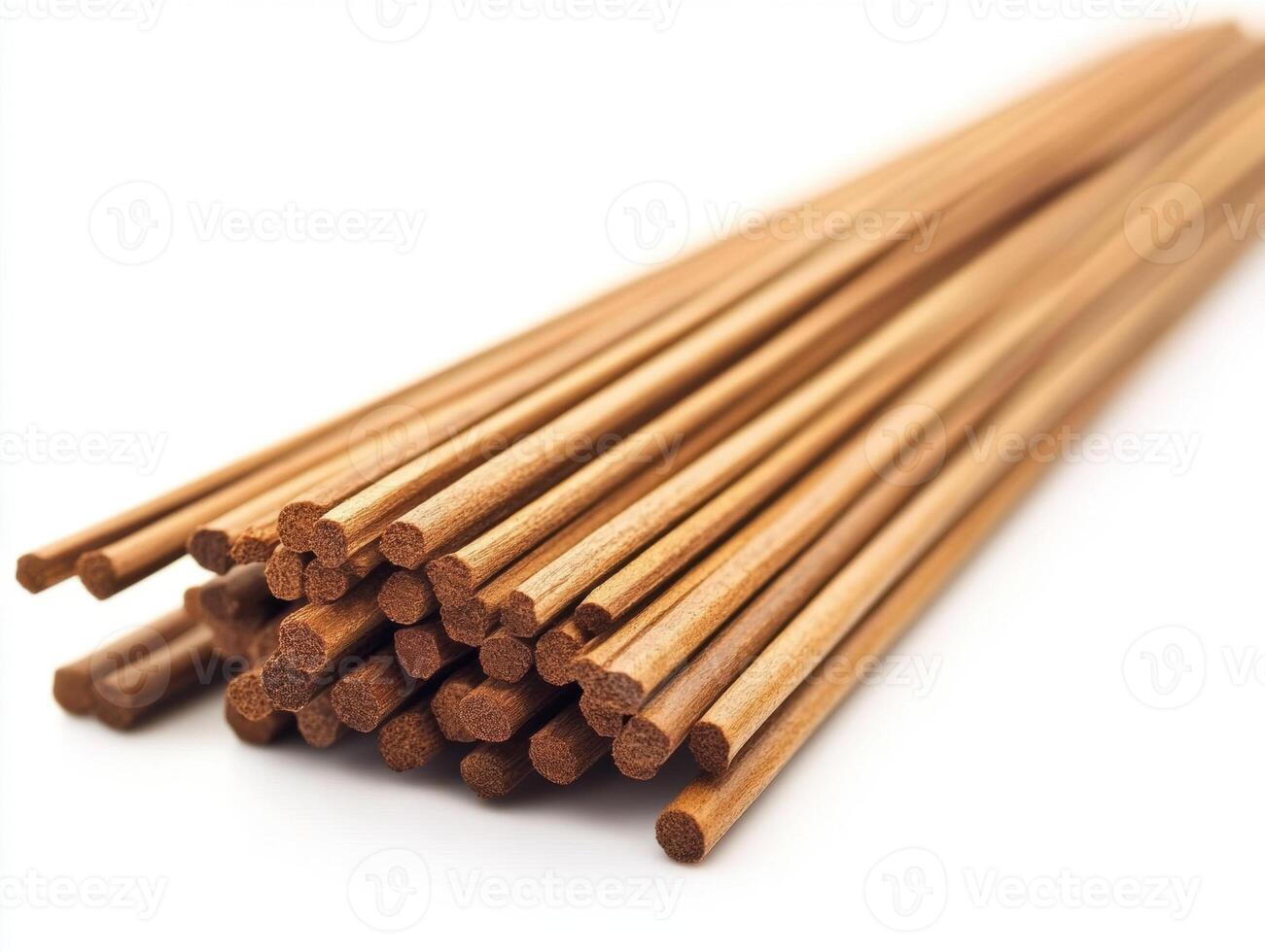 Natural wooden sticks arranged neatly in a pile on white background photo