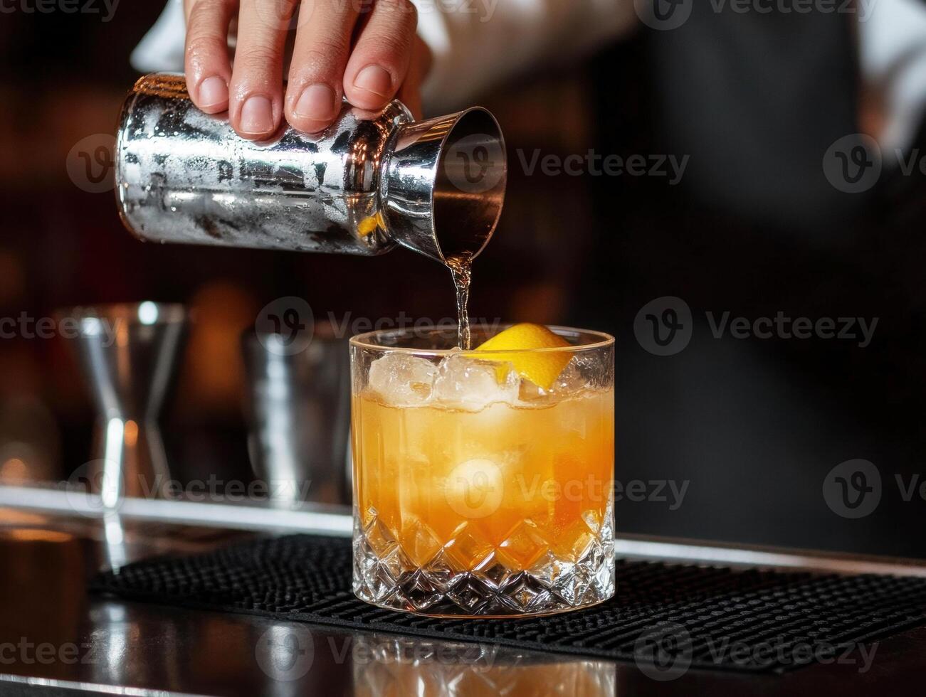 Bartender prepares cocktail with citrus garnish in a bar setting photo