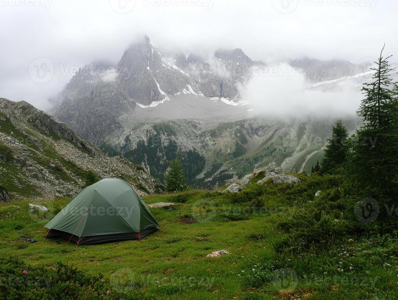 Mountain camping experience in serene landscape under cloudy skies photo