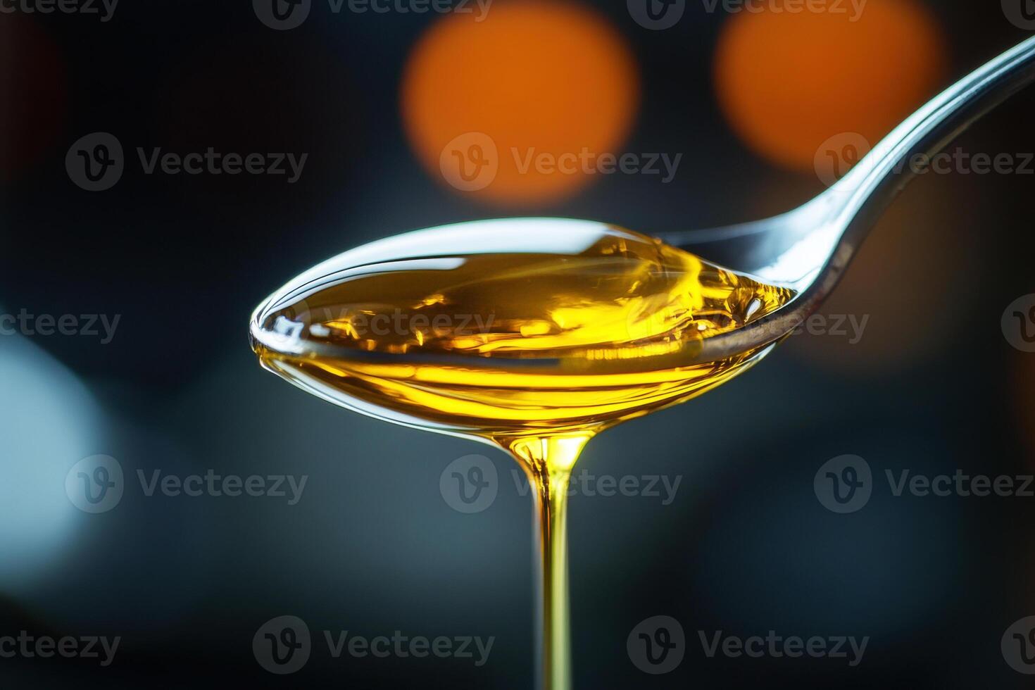 Honey drizzle on a silver spoon capturing golden textures photo