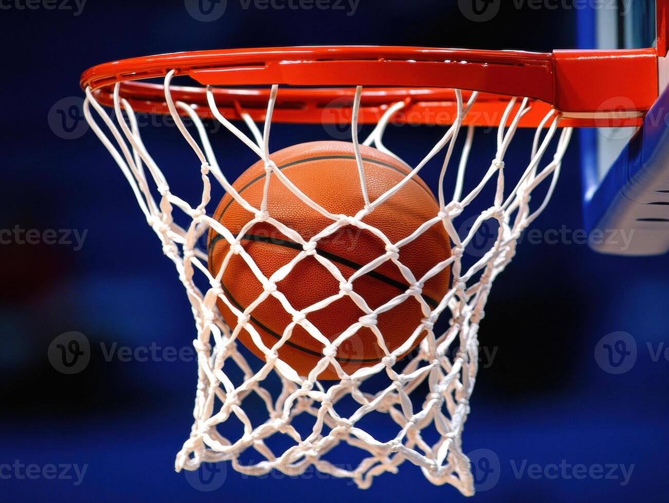 Basketball smoothly lands in the hoop during a competitive game photo