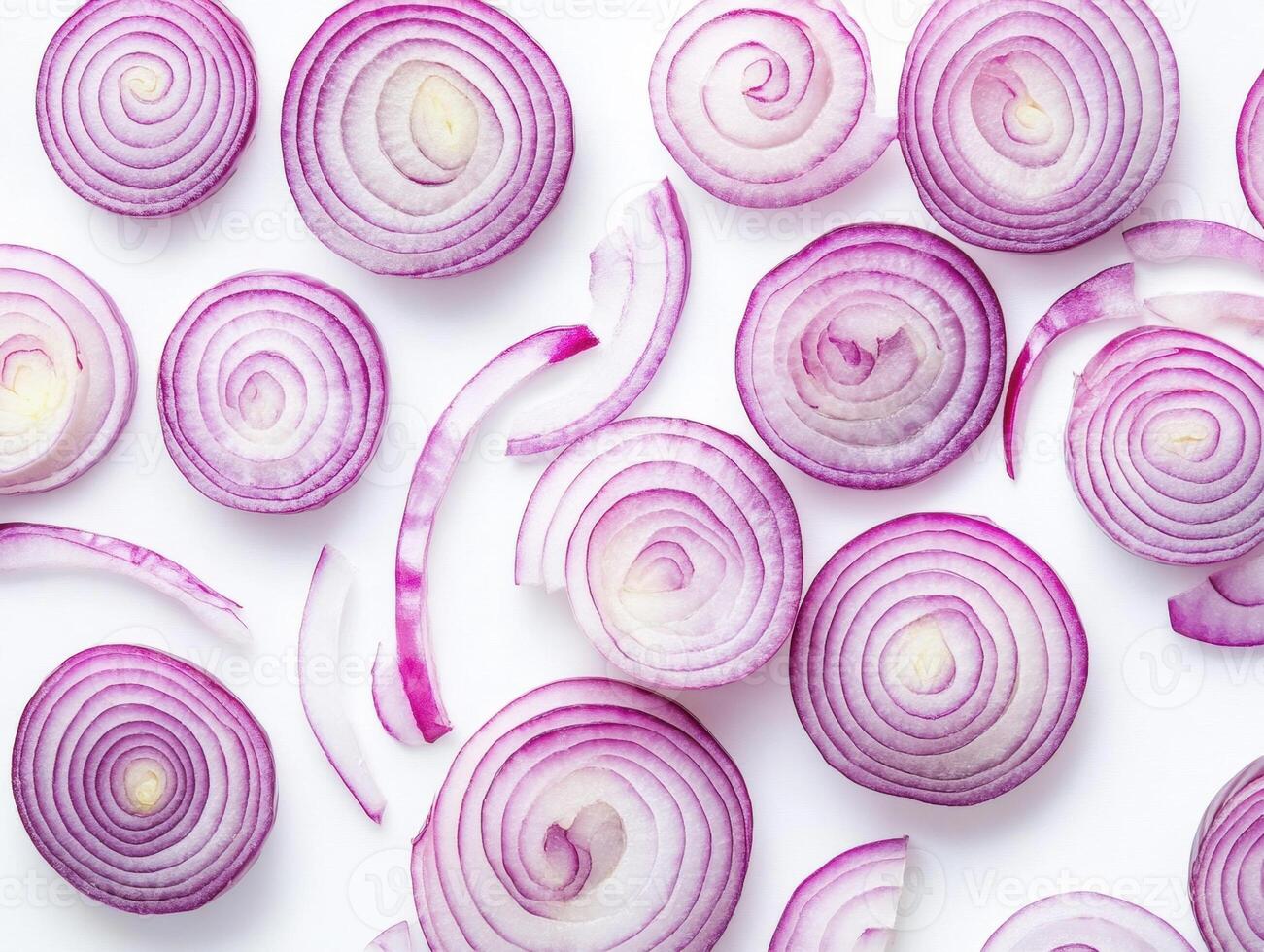 Sliced red onions arranged on a white surface photo