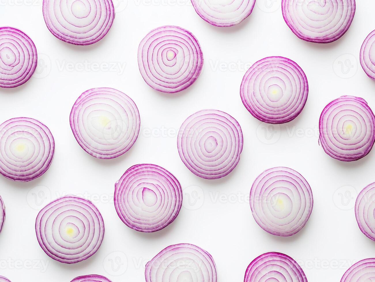 Sliced red onions arranged in a circular pattern on a white surface photo