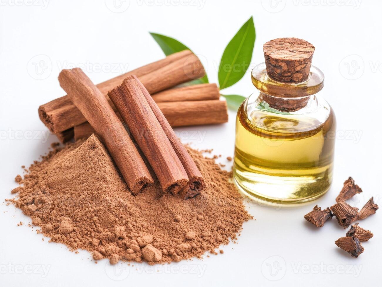 Cinnamon sticks, powder, and essential oil arranged on a white surface photo