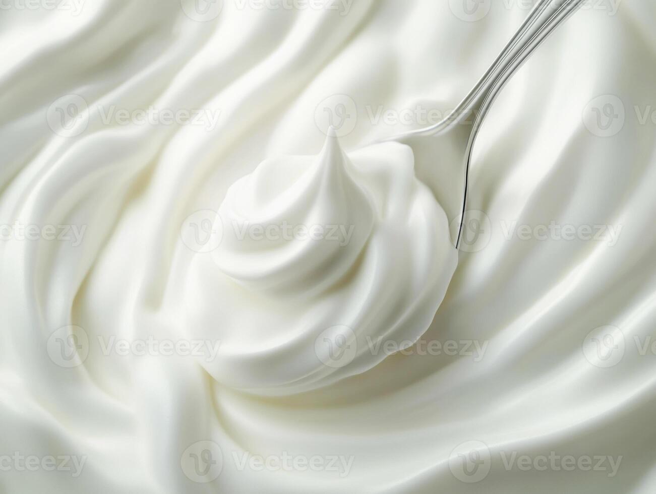 Creamy whipped topping swirled in a bowl with spoon photo