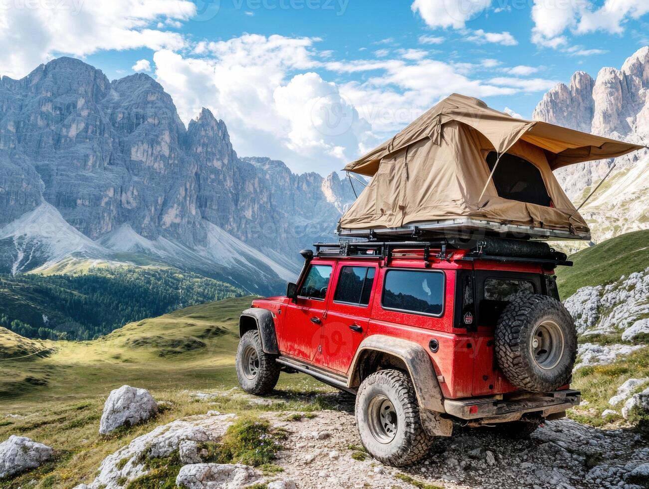 Camping in the mountains with a rooftop tent on a rugged vehicle photo