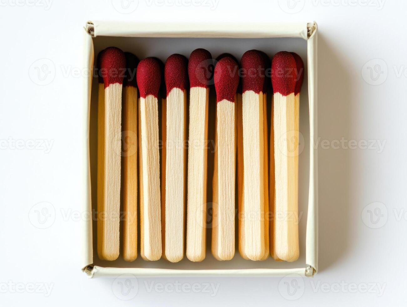 Matches grouped in a box with striking heads visible photo