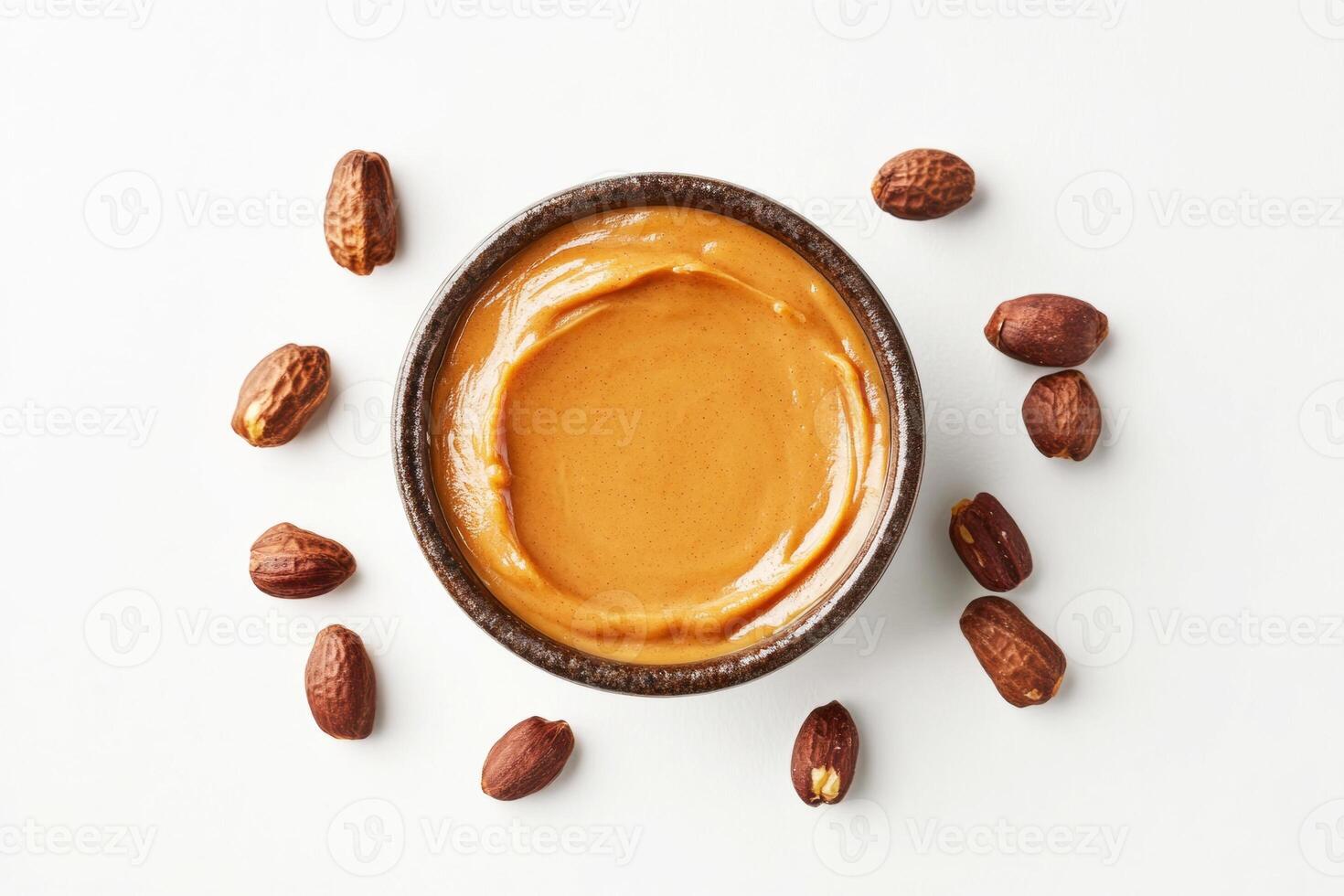Nut butter in a bowl surrounded by cocoa beans on a white background photo
