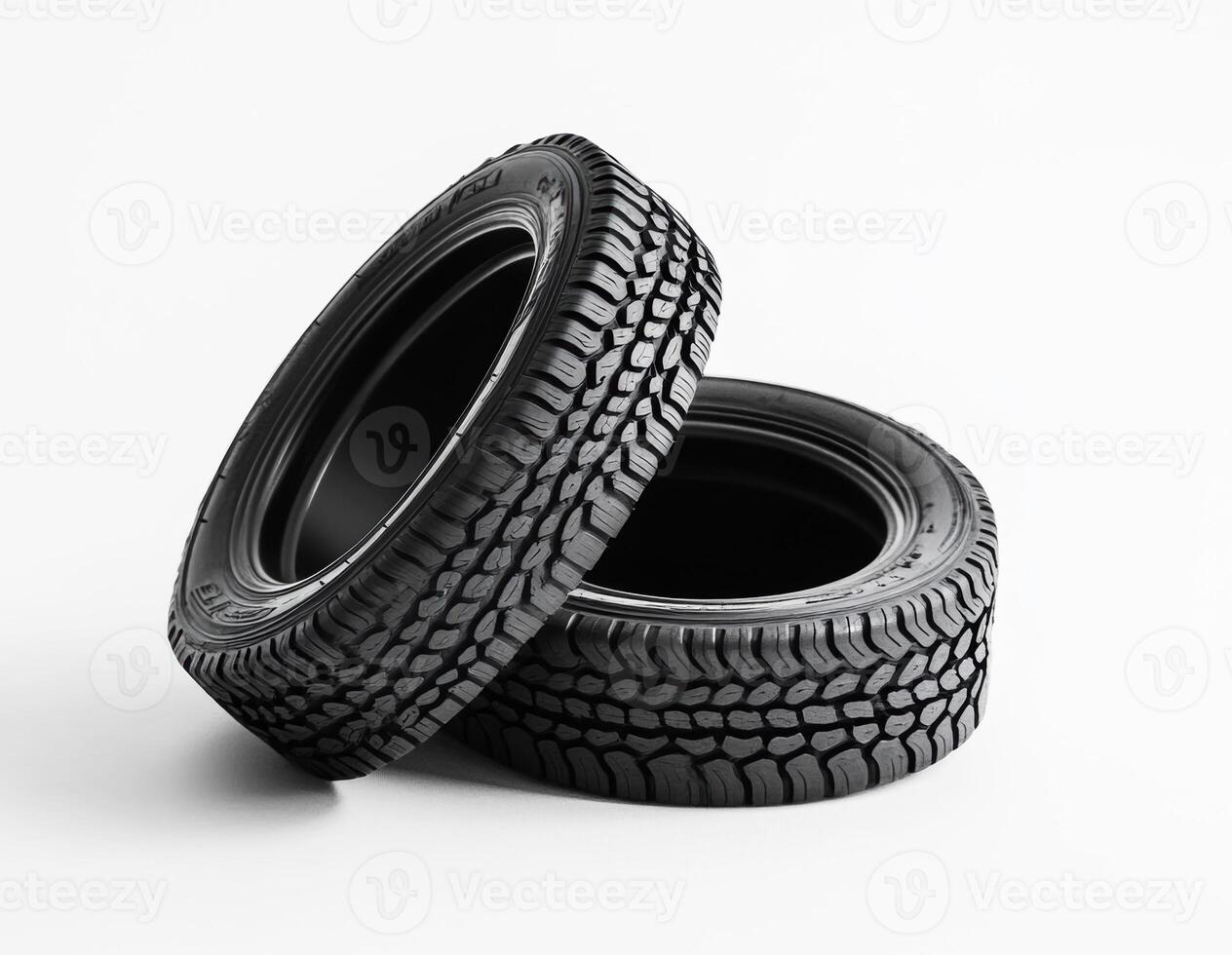 Two black tires stacked on a white background photo