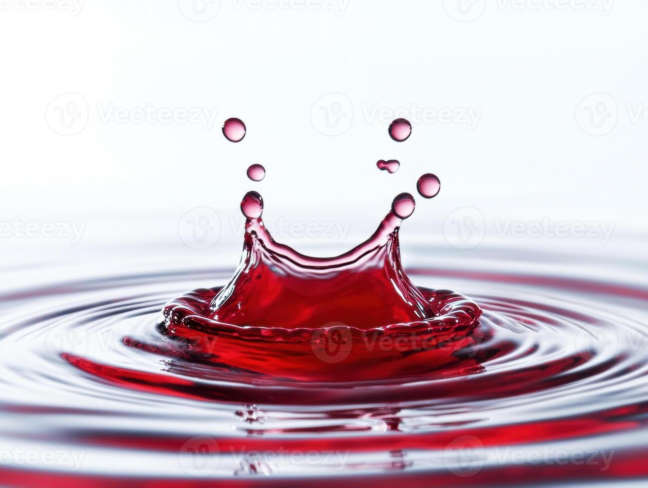 Water splash creates dynamic ripples in red liquid photo