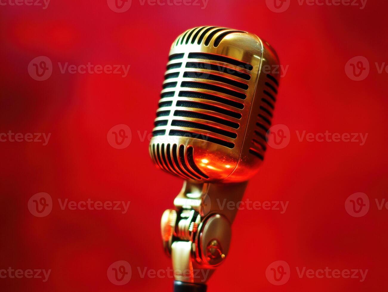 microphone stands against a vibrant red background photo