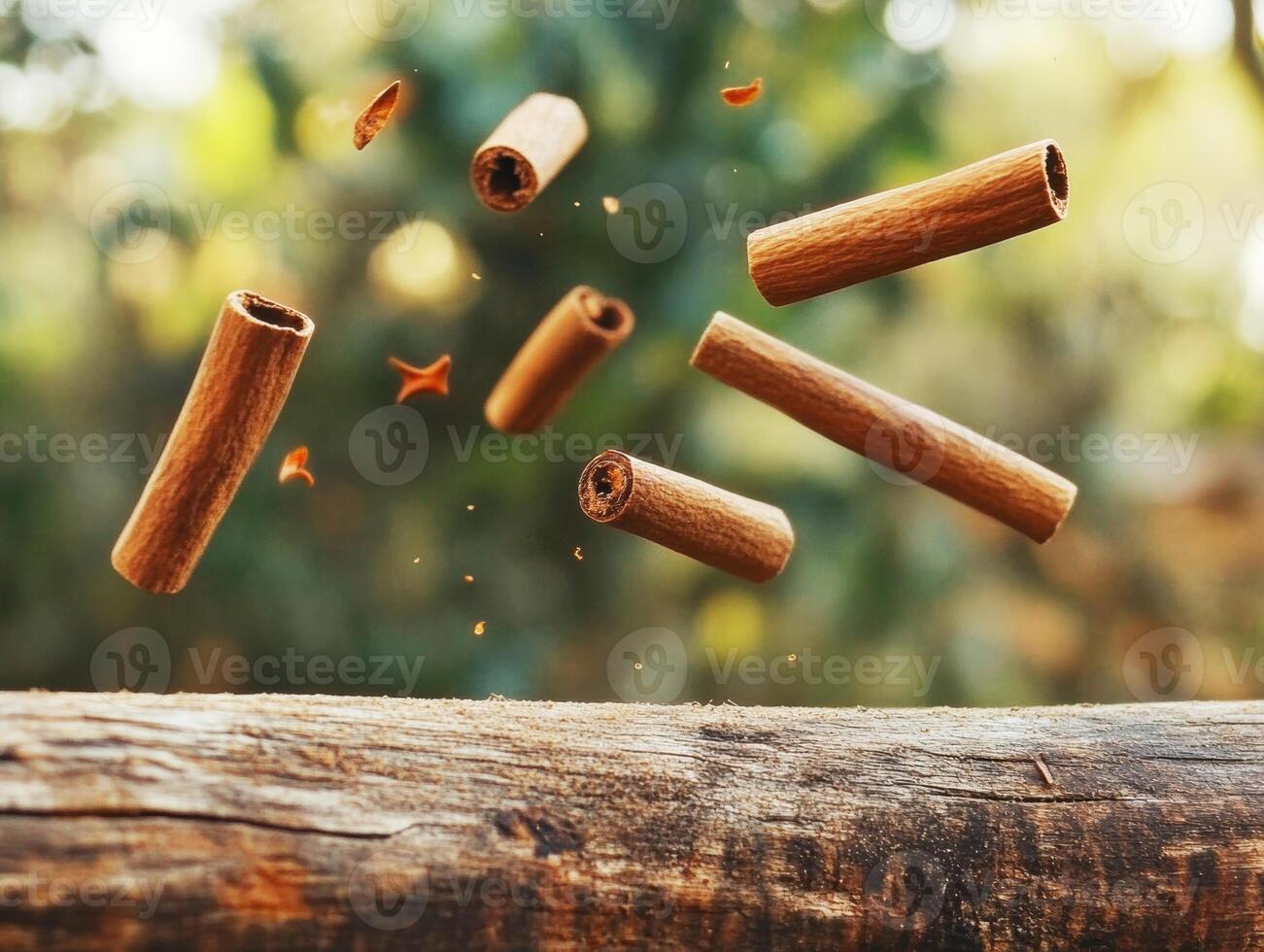 Cinnamon sticks floating in the air above a rustic wooden surface photo