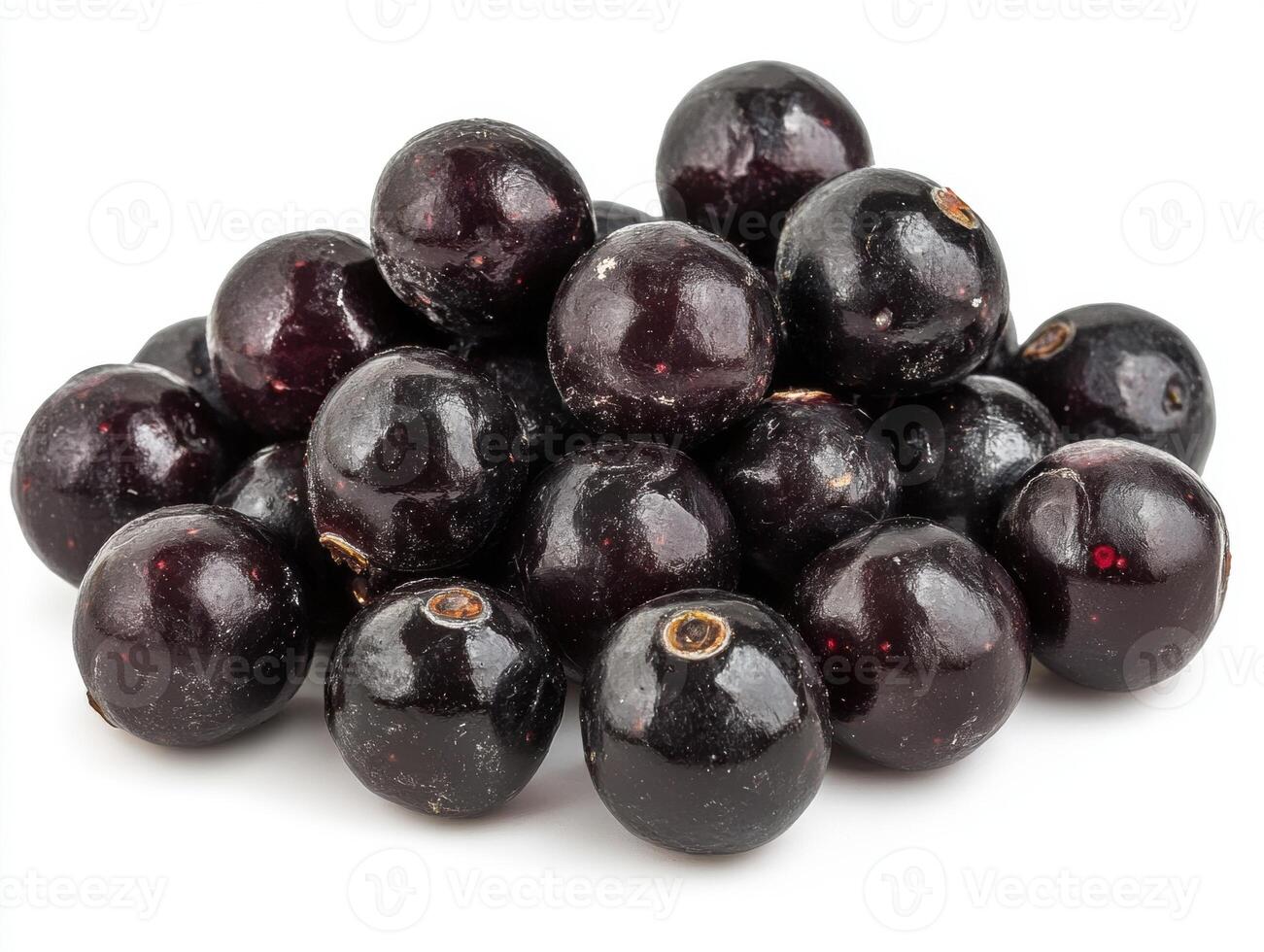 Fresh black currants stacked in a pile on a white surface photo