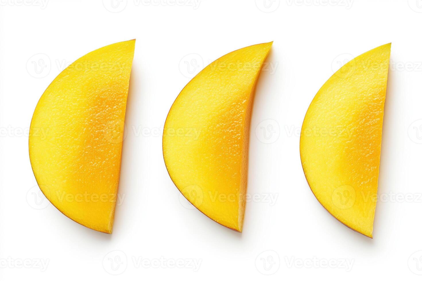 Bright yellow mango slices arranged in a row on a white background photo