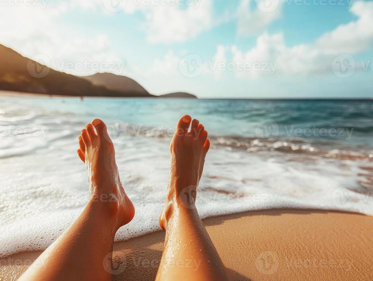Relaxing on the beach with feet in the sand during sunset hours photo