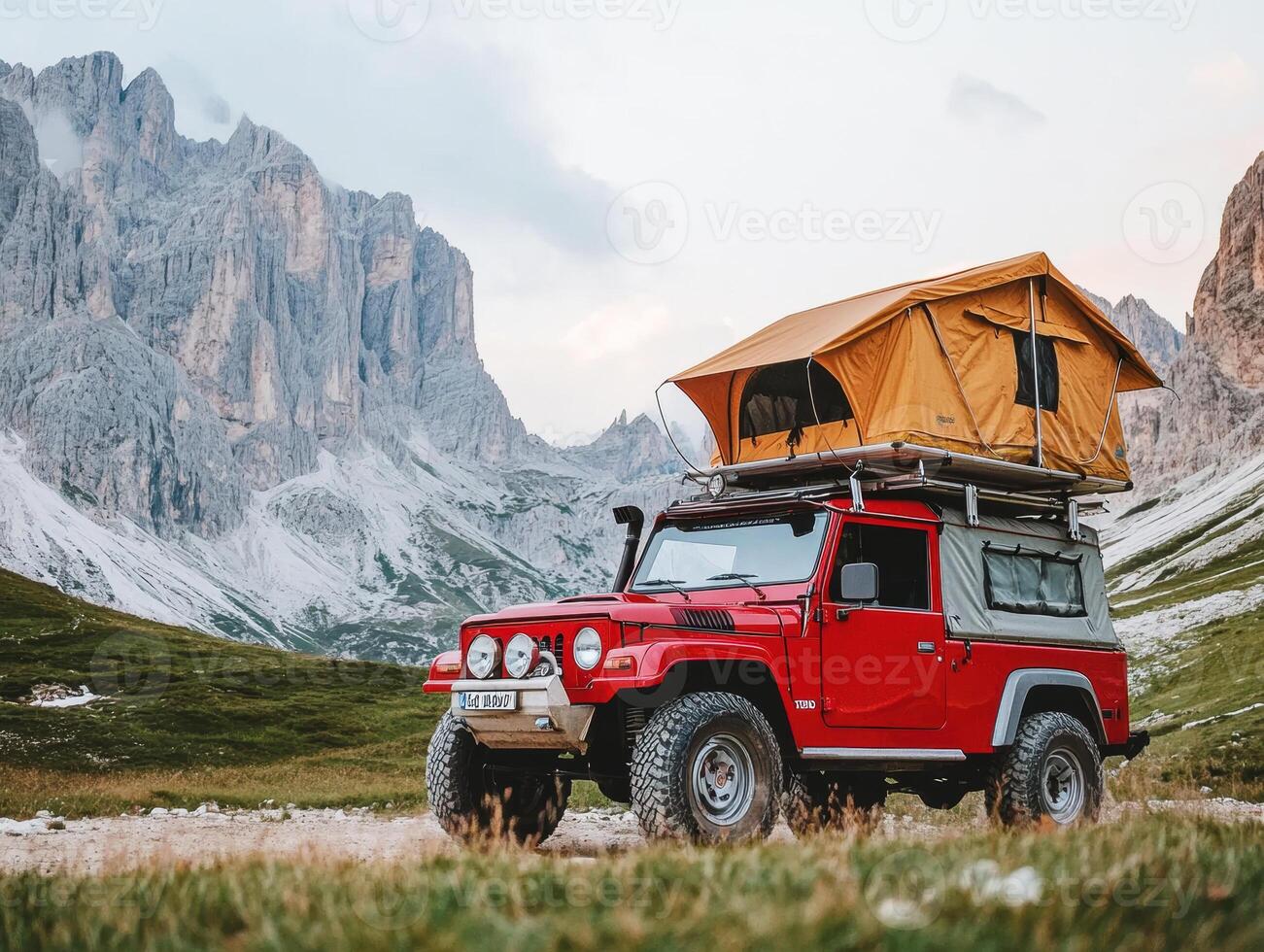 Camping adventure in the Dolomites with a red SUV and rooftop tent photo