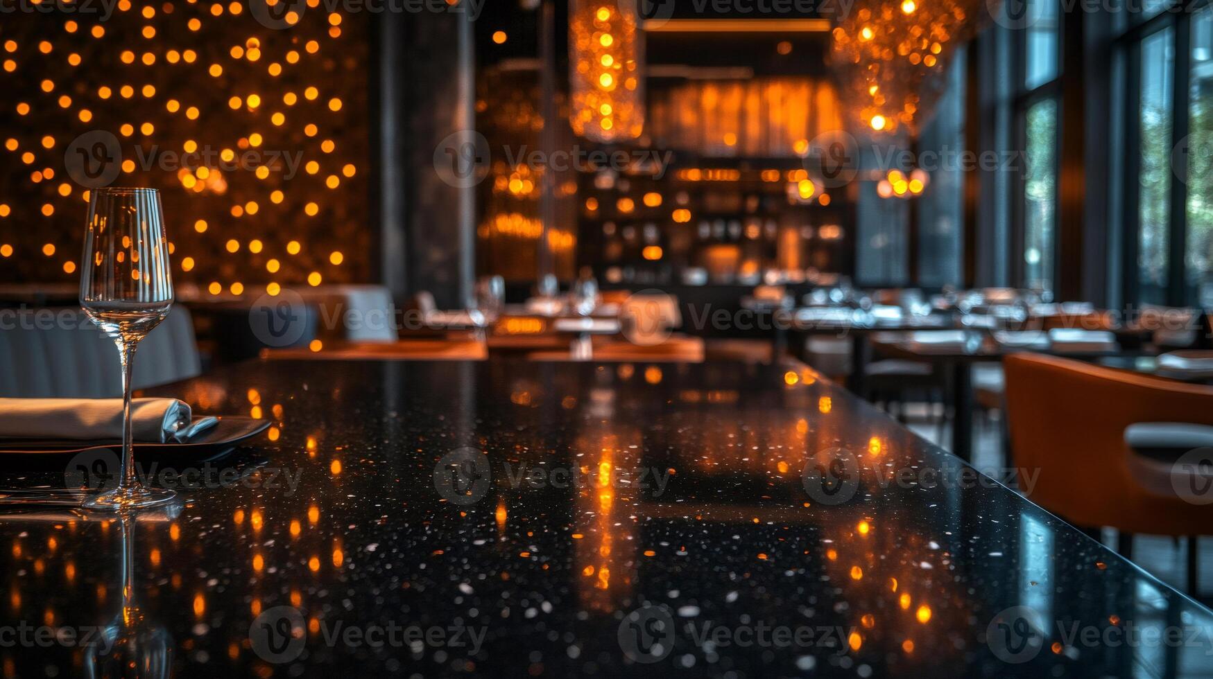 Elegant wine glass standing on gleaming restaurant table reflecting warm lighting photo
