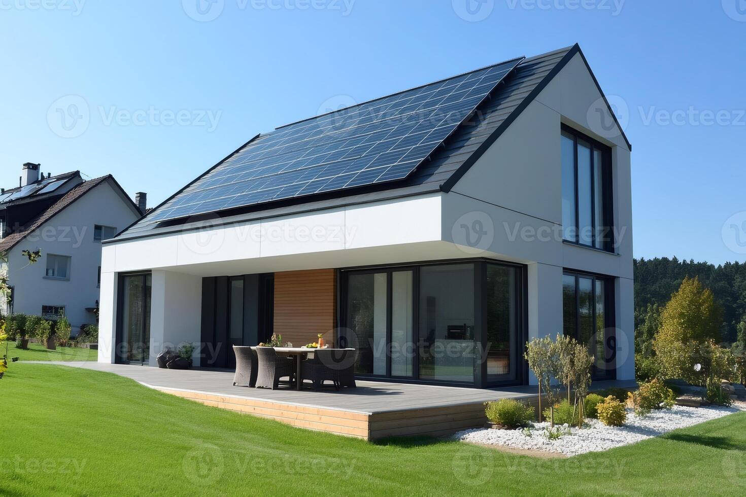 Modern house with solar panels generating green energy on a sunny day photo