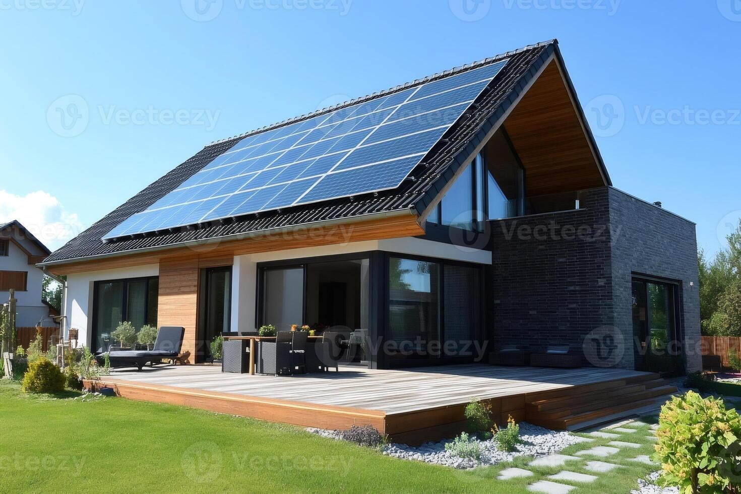 Modern house with solar panels generating green energy on sunny day photo