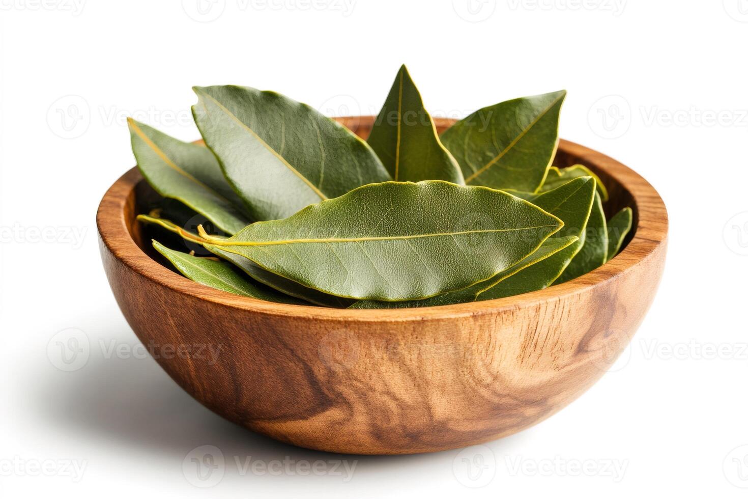Fresh bay leaves resting in wooden bowl on white background.. photo