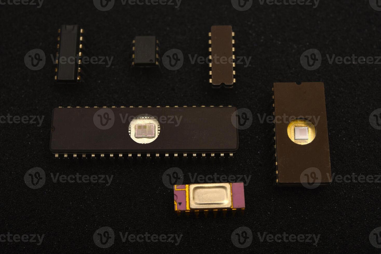 Vintage microchips arranged on dark foam background.Several microchips on black foam. Old integrated circuits for radio electronics. photo