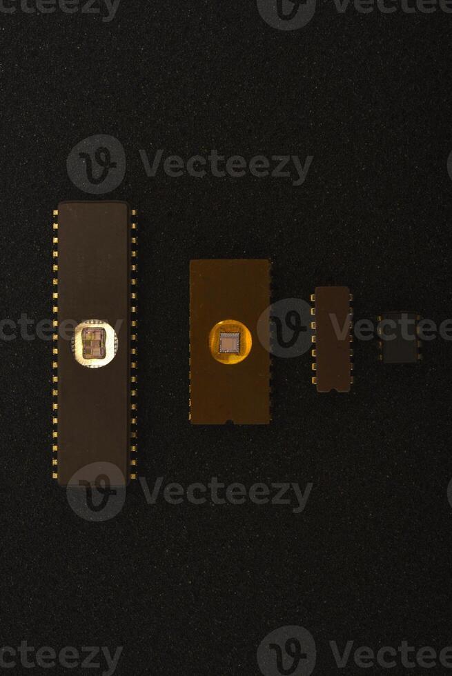 Several microchips on black foam. Old integrated circuits for radio electronics. photo