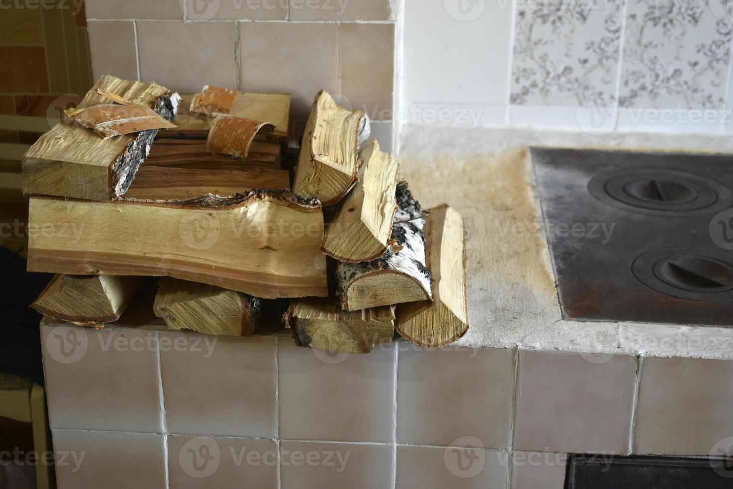 Firewood on the stove in the house. Chopped firewood. photo