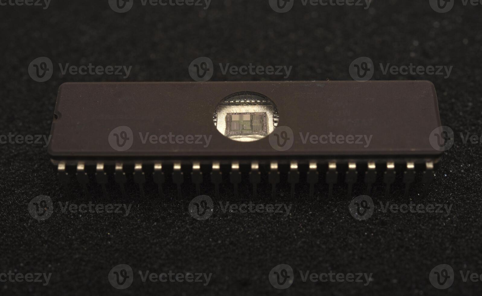 Antique silicon chips with metallic pins. The microcircuit is on black foam. An integrated circuit for radio electronics. photo