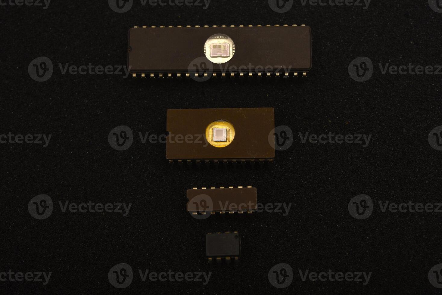 Retro-tech components for repair projects. Several microchips on black foam. Old integrated circuits for radio electronics. photo