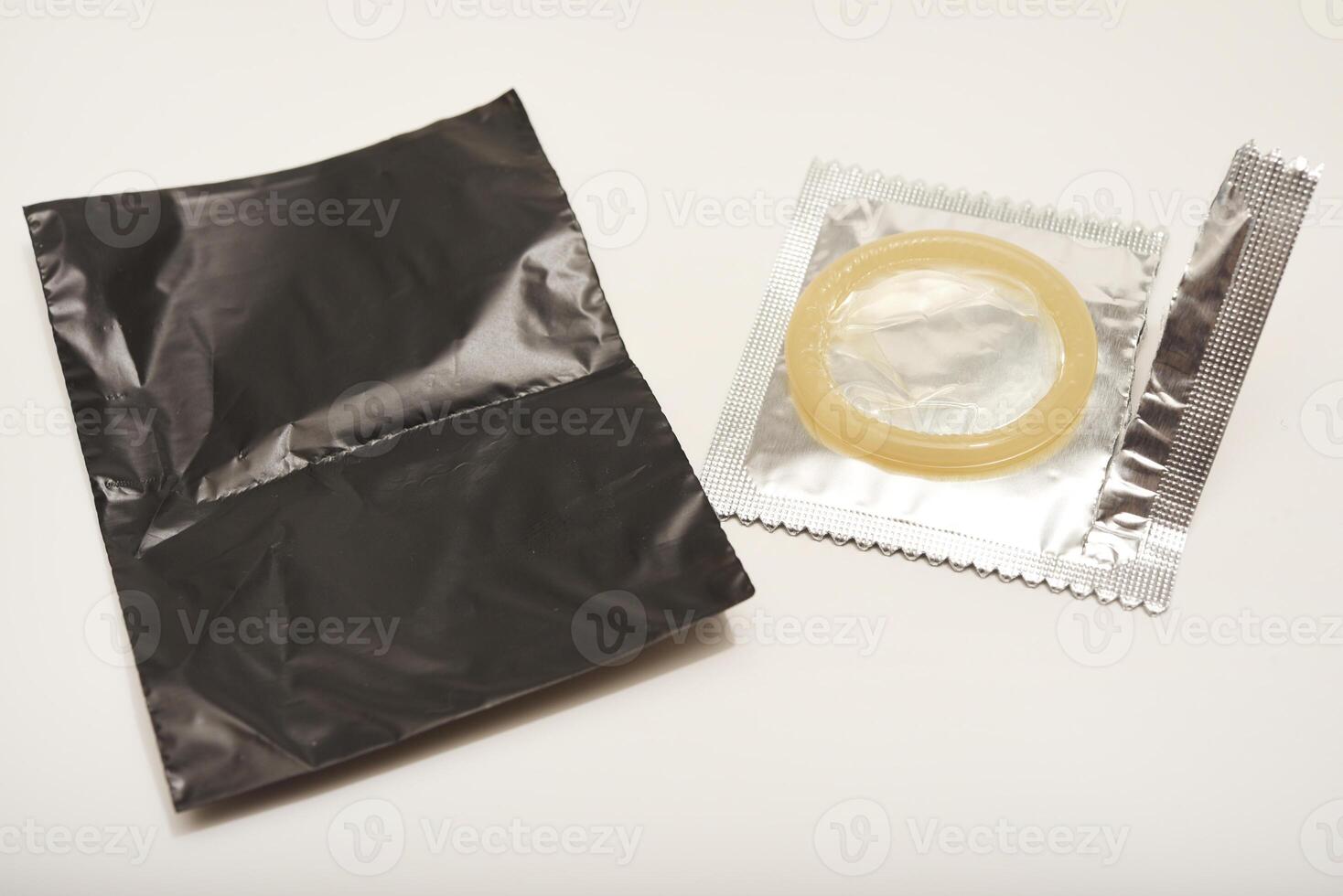 An open condom in a package. Male contraceptives. Ultra-Thin Design, Maximum Comfort photo