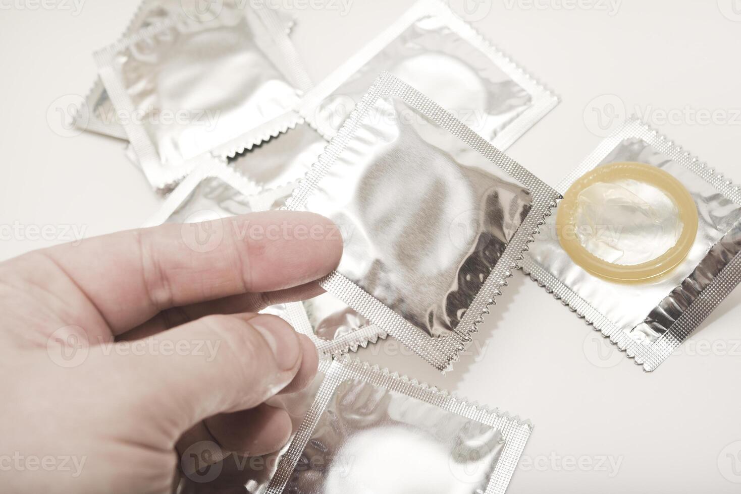 Discreet Packaging, Confident Choice. An open condom in a package. Male contraceptives. The condom is in your hand. photo