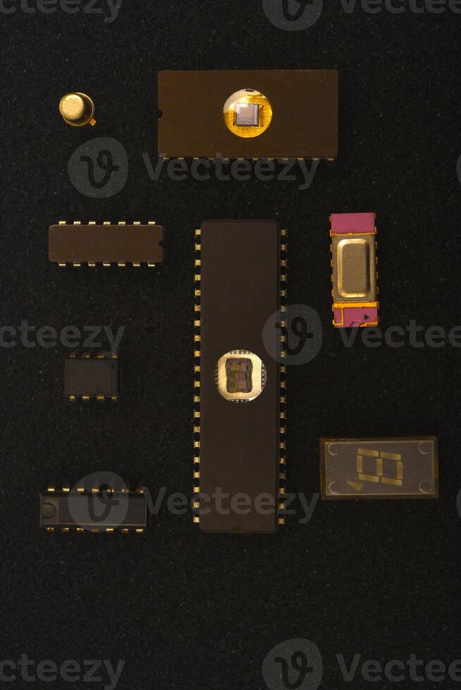 Classic microprocessors on foam padding. Several microchips on black foam. Old integrated circuits for radio electronics. photo