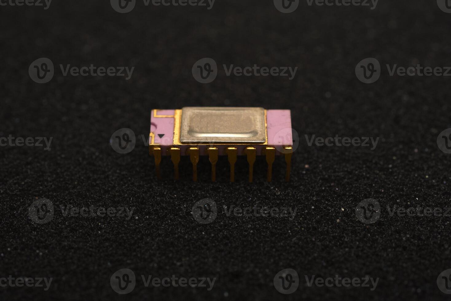 Obsolete PCB components collection. The microcircuit is on black foam. An integrated circuit for radio electronics. photo