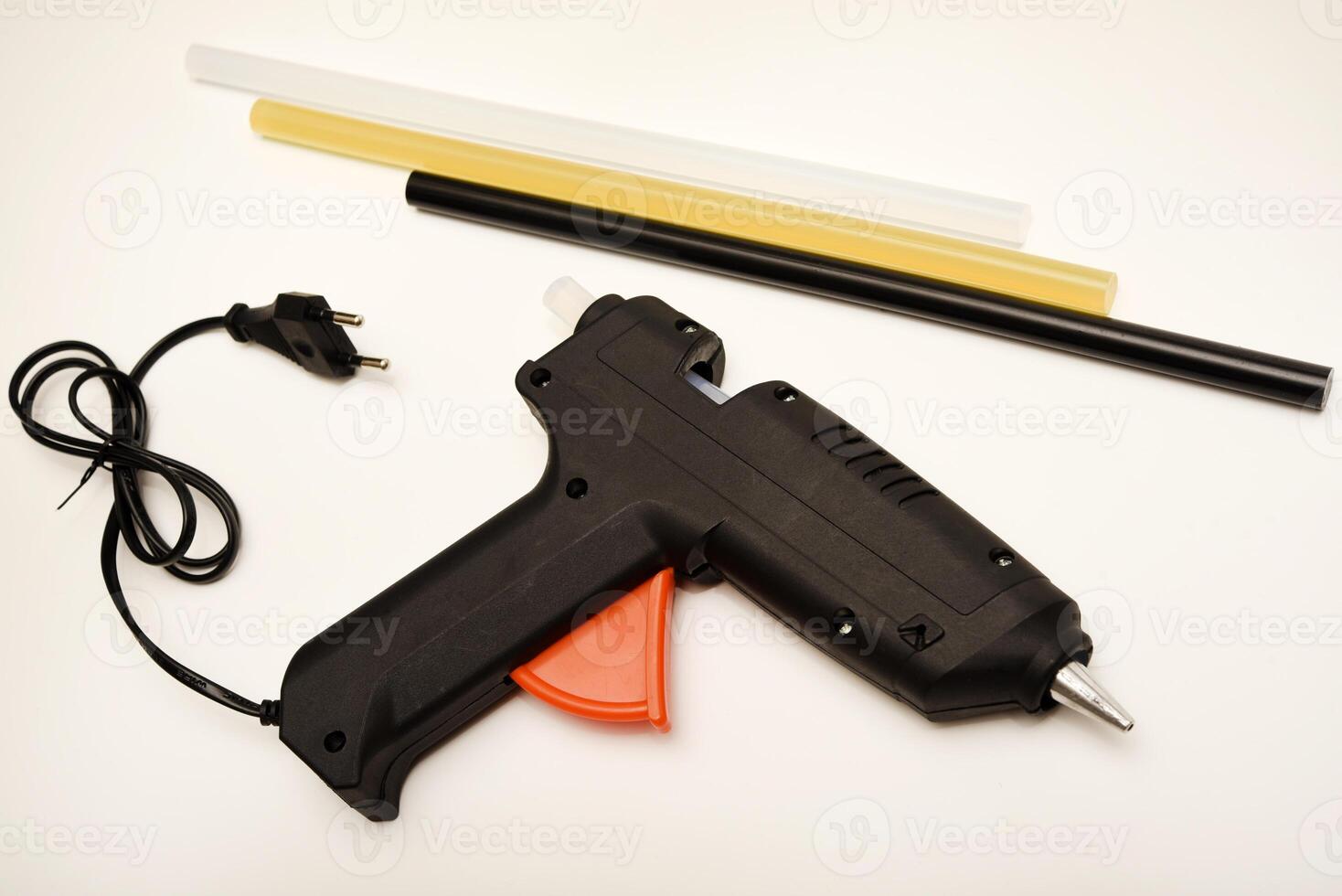 Black glue gun. A tool for gluing. photo