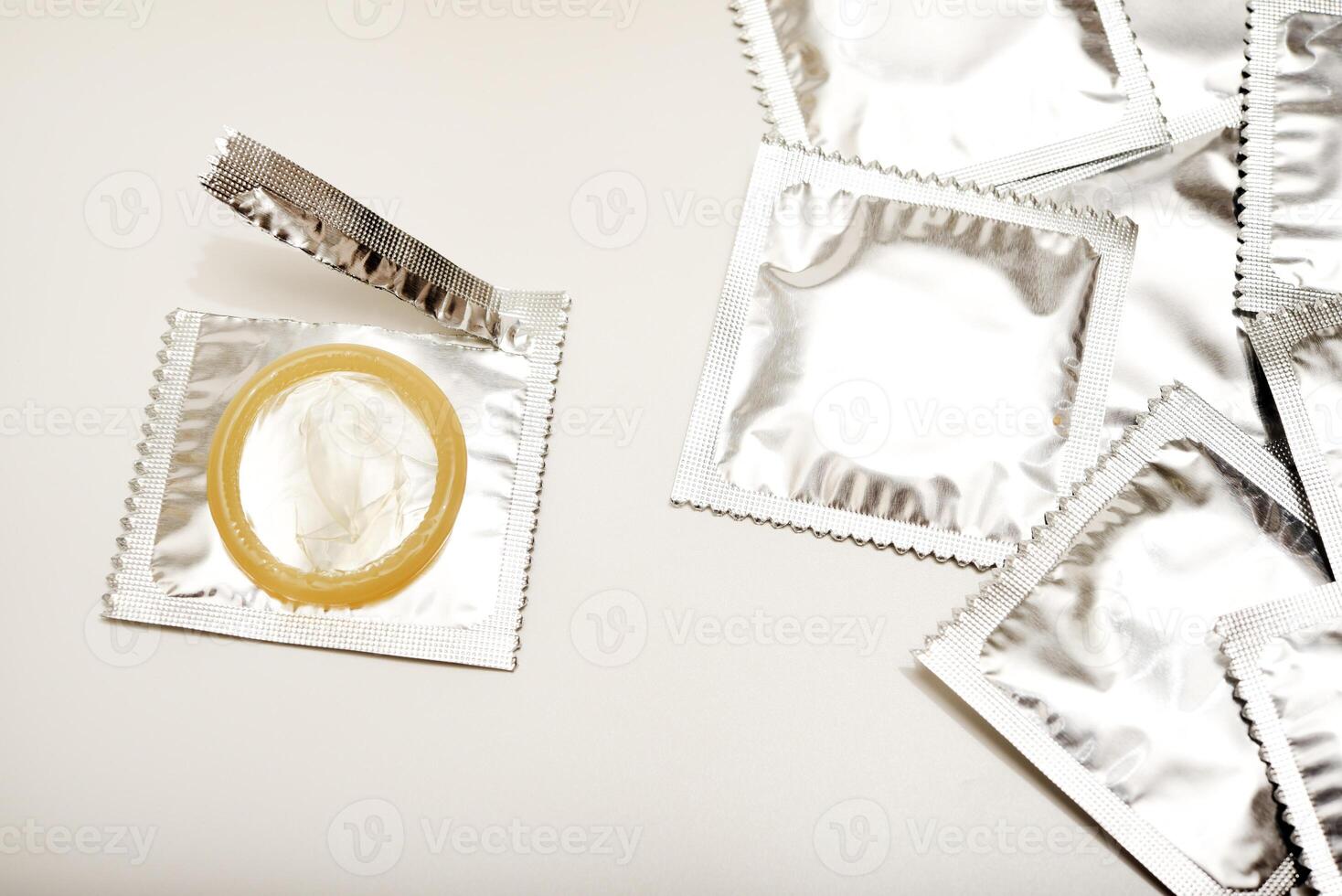 An open condom in a package. Male contraceptives. Enhanced Sensitivity, Natural Feel. photo