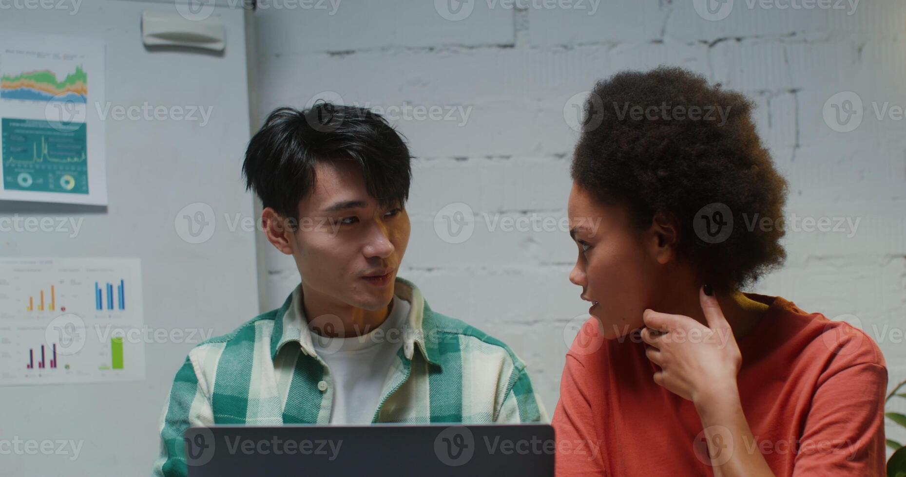 A couple work in a place, sitting at laptop in a office and enjoying each other photo