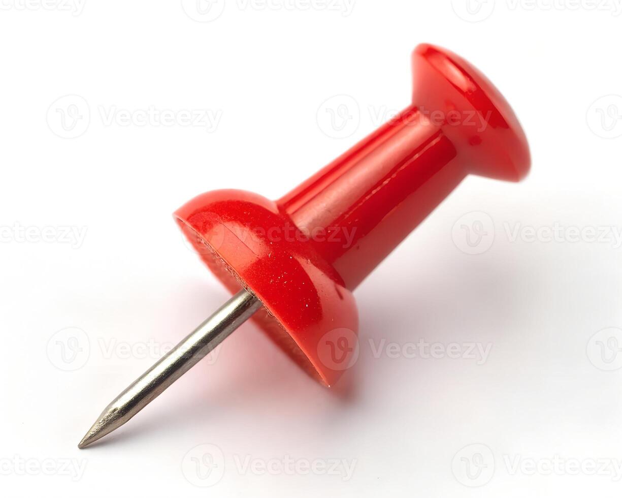 A vibrant red pushpin, poised and ready, symbolizes a crucial detail, a bold statement against a stark white background. photo