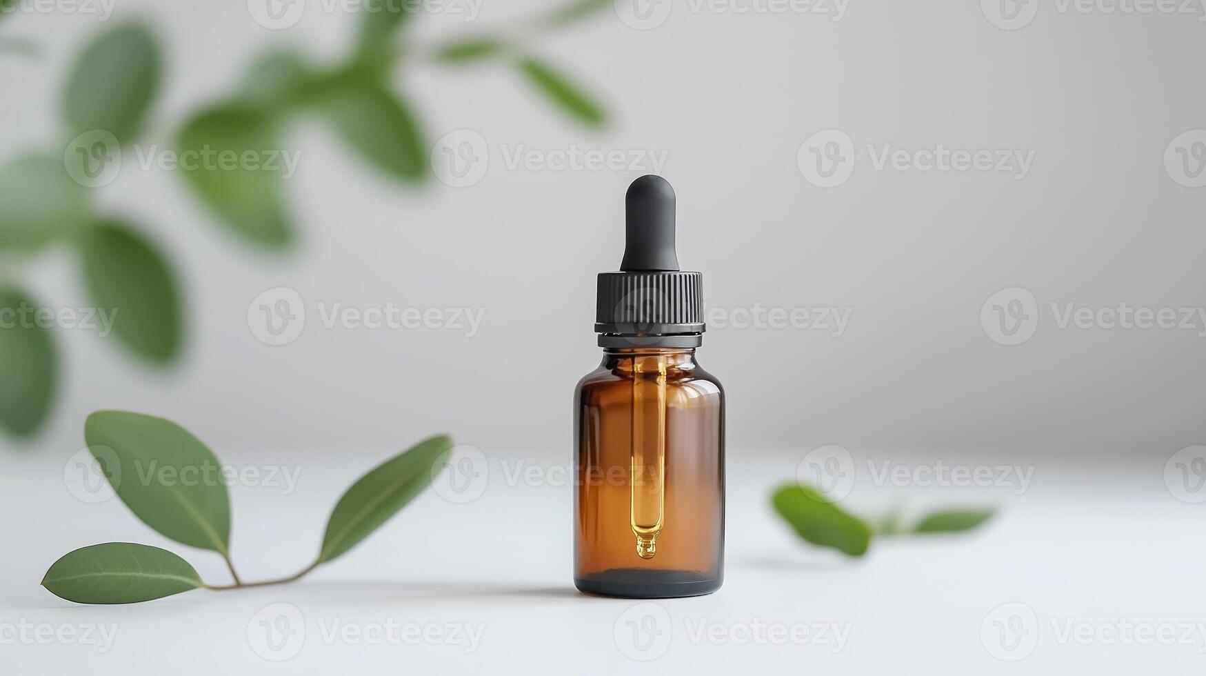 Bottle of herbal oil placed on a light surface surrounded by green leaves in a serene setting photo