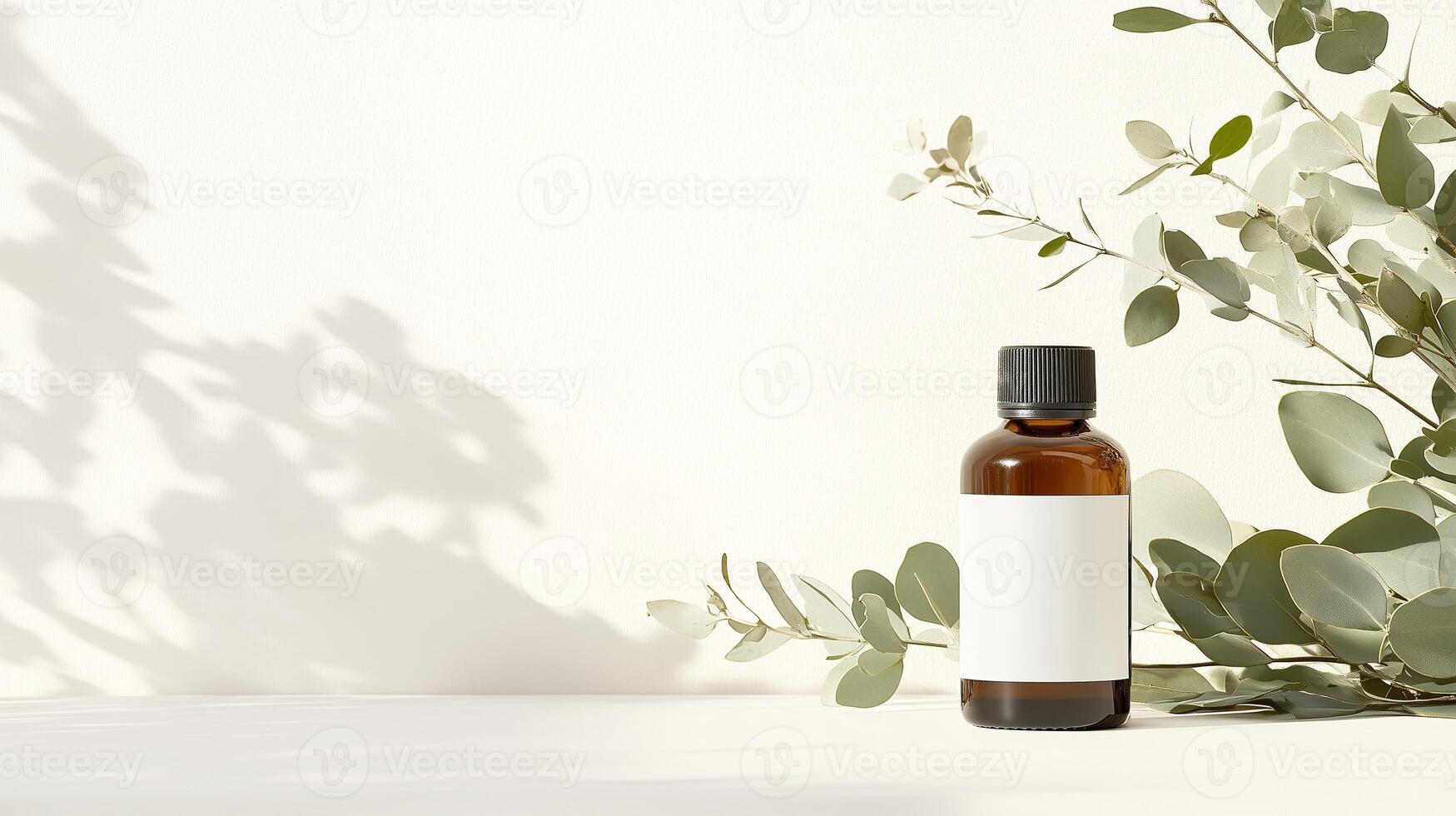 Eucalyptus essential oil bottle with blank label and green leaves on a neutral background in a bright setting photo