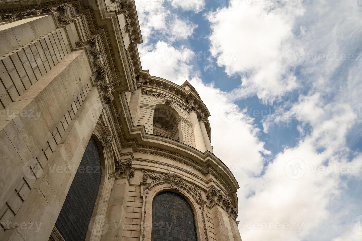 An angled perspective of St. Paul s Cathedral highl g hts its sculpted facade and elegant curved stonework. photo