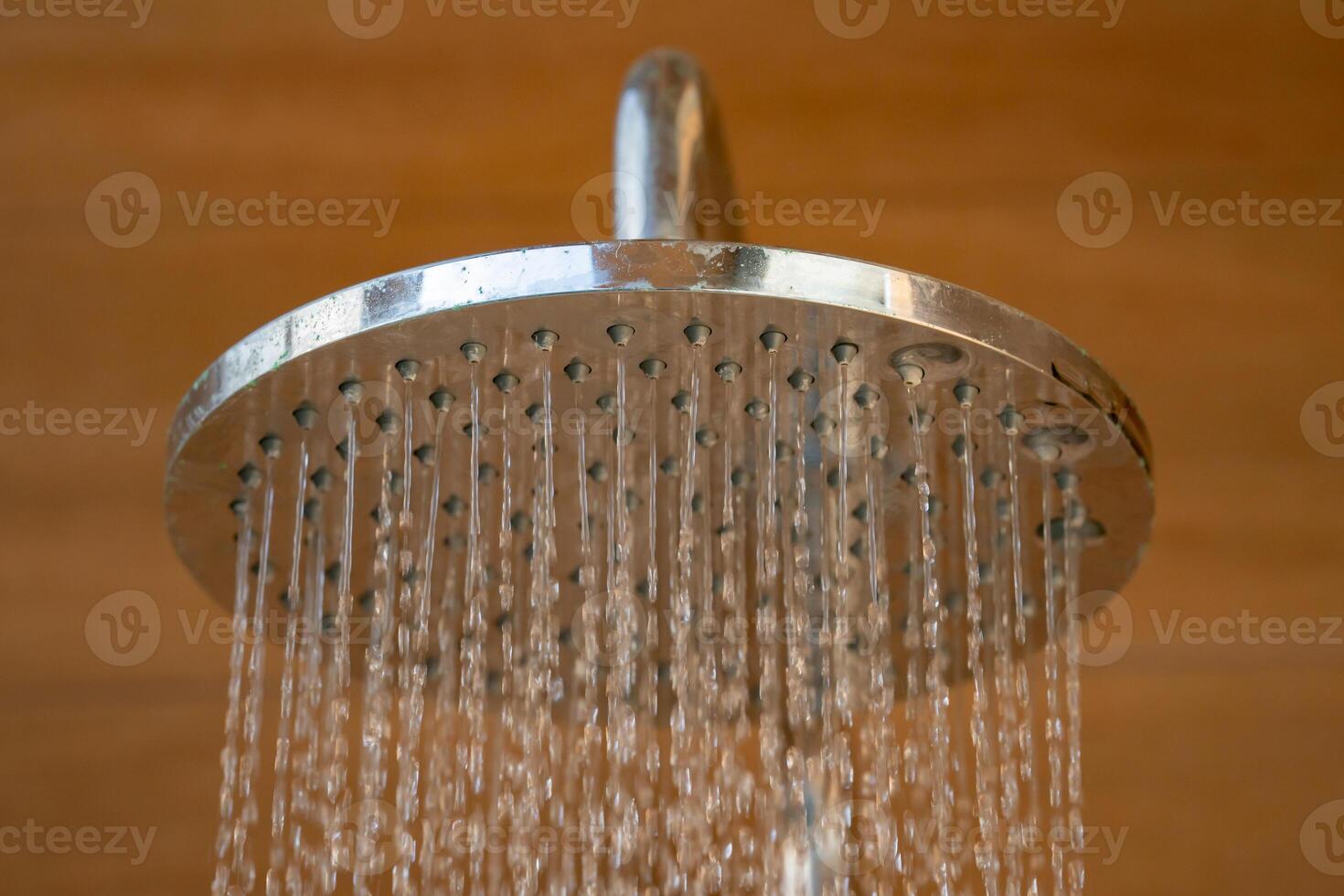 Close up to Outdoor shower head for the bath and showering cold water to body before jumping in the resort pool.1 photo