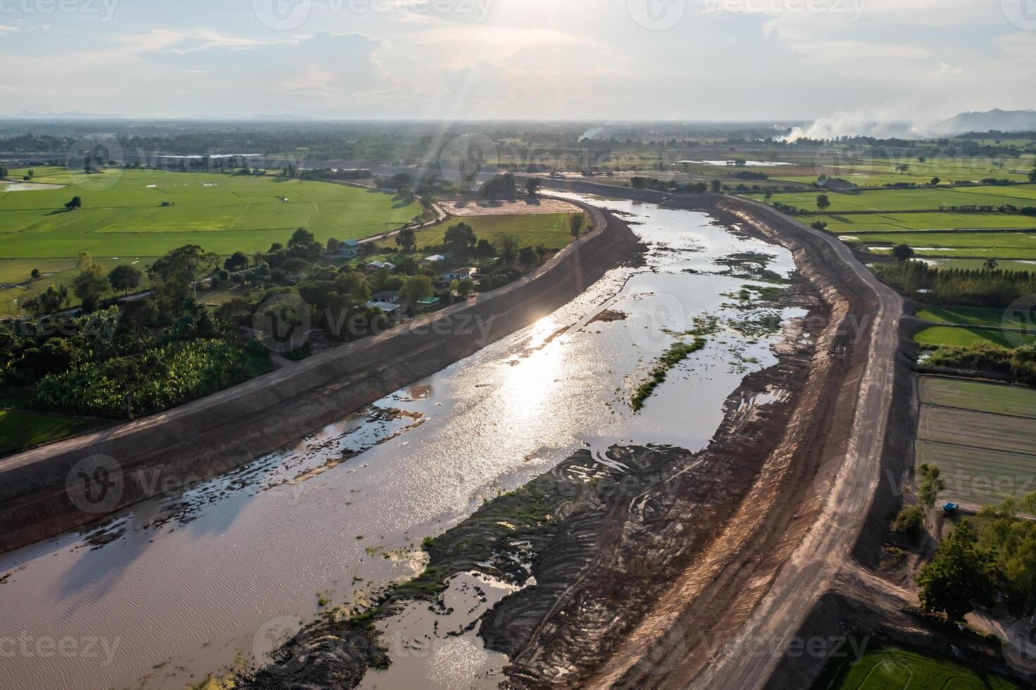 Construction dredges up for a canal and dam, to prevent a flood in the rainy season. Date on 14 May 2021 at Uthai Thani province, Thailand.1 photo
